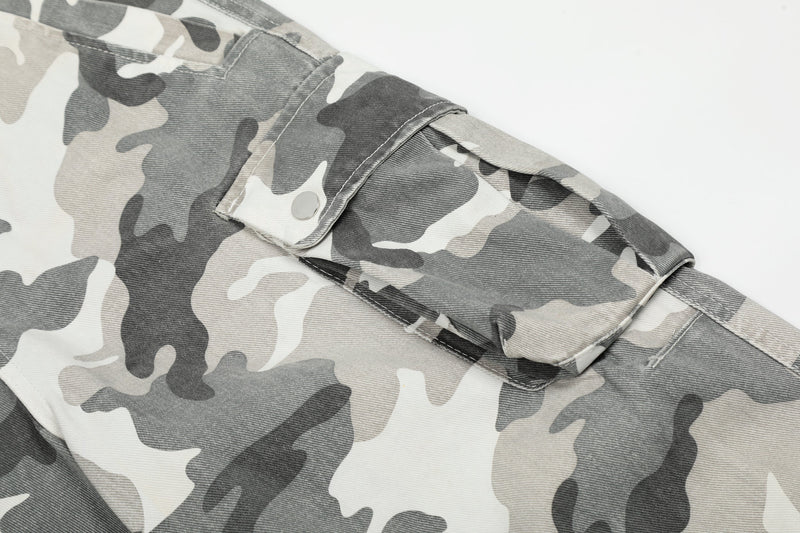 Close-up of a side cargo pocket with snap flap on gray and white camouflage pants