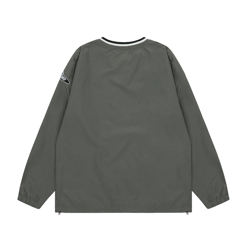 Back view of dark gray oversized windbreaker with black and white ribbed neck trim