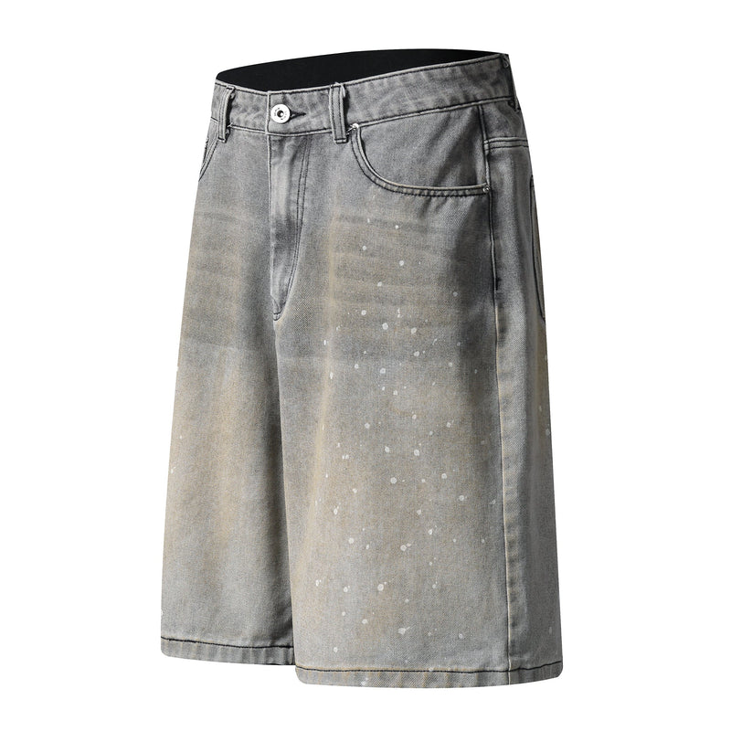 Angled front view of grey wash wide-leg denim shorts with speckled fade and coin pocket
