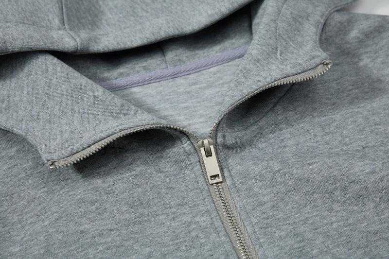 Close-up of gray hoodie hood opening and zipper at the front
