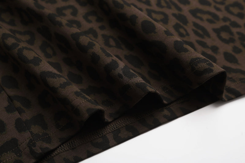 Close-up of a brown leopard print T-shirt hem with folded fabric and visible stitching on a white background