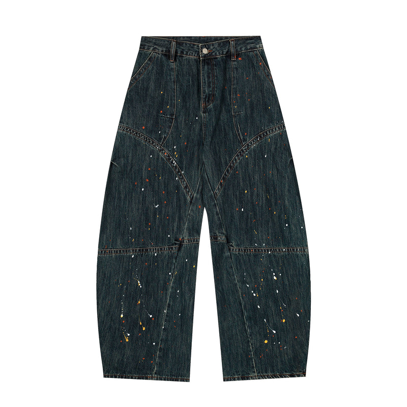 Dark wash wide-leg jeans with paint splatter and patchwork seams, front view