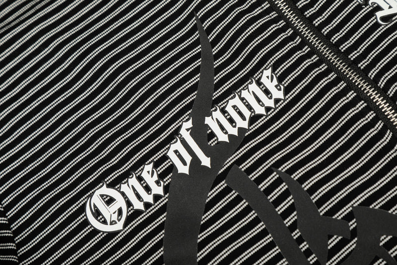 Close-up of chest graphic and zipper detail on black striped hoodie