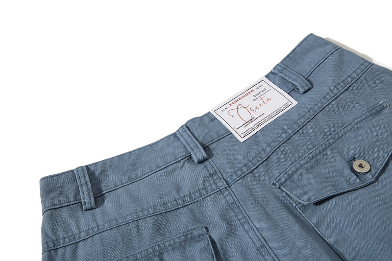 Close-up of blue cargo pants back waistband label and belt loops