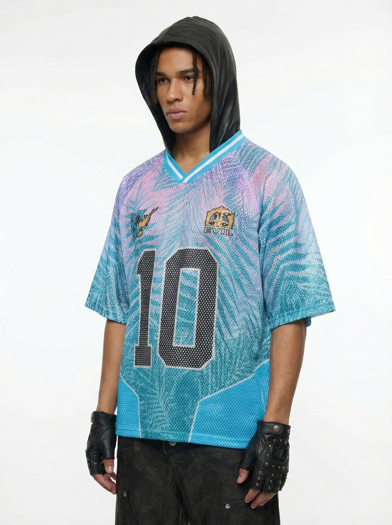 Model wearing a blue and pink mesh jersey T-shirt with a large number 10, hood, and black gloves
