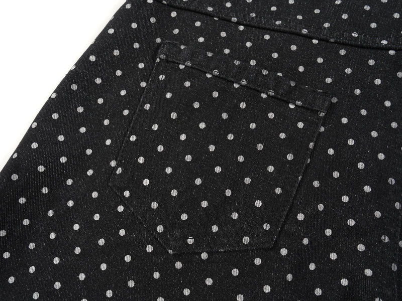Close-up of back pocket on black polka-dot denim pants