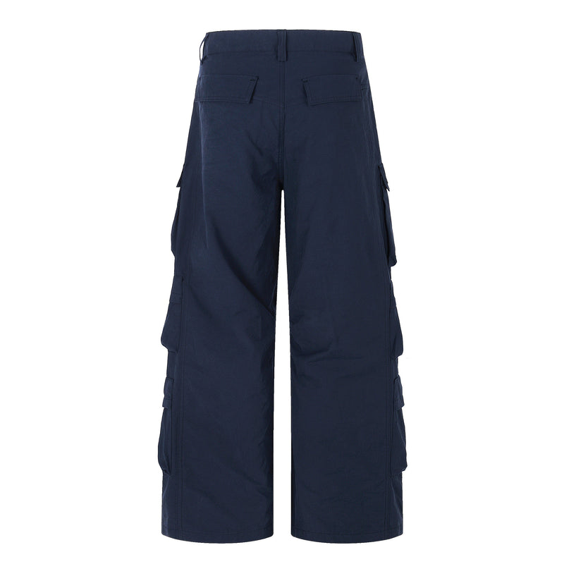 Back view of navy wide-leg cargo pants with flap back pockets and straight wide legs