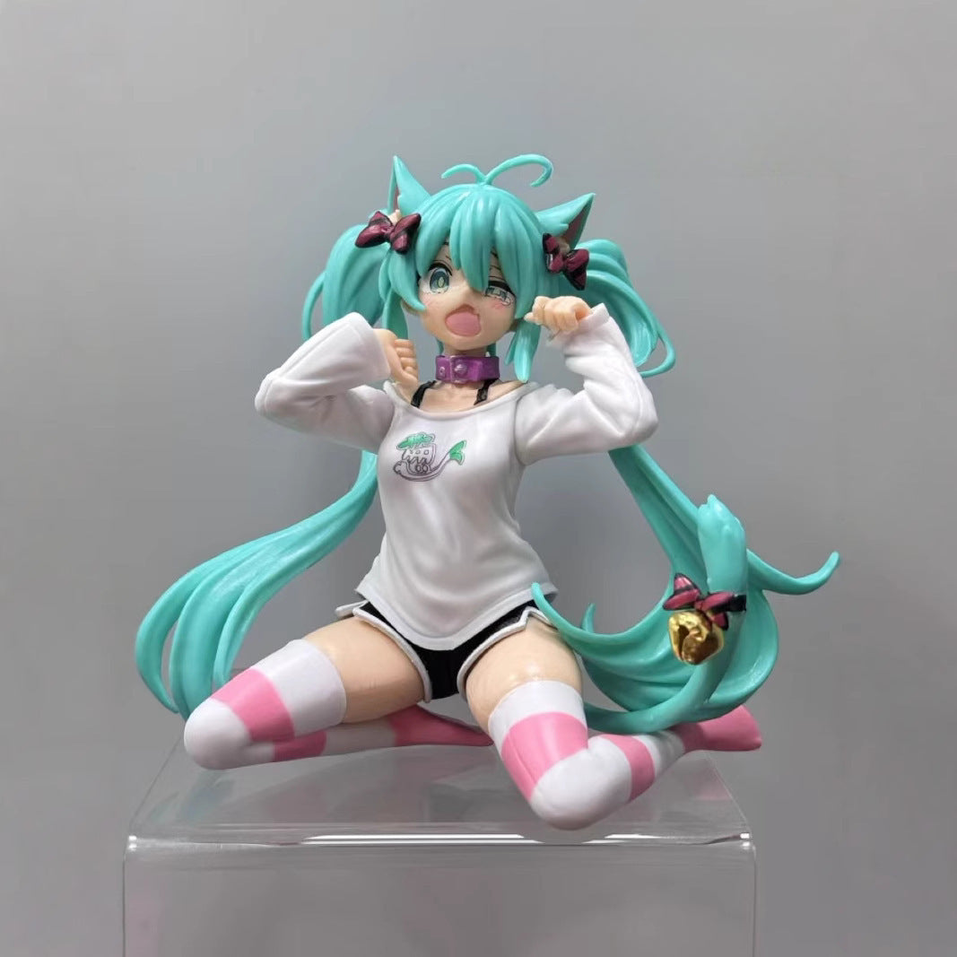 The Kneeling Cat-Ear Hatsune Miku 11cm PVC Figure features teal hair, cat ears, a white long-sleeve shirt, striped pink and white socks, black shorts, and a clear platform. This cute &amp; playful collectible by Hatsune Miku showcases an energetic expression ideal for anime figure collectors.