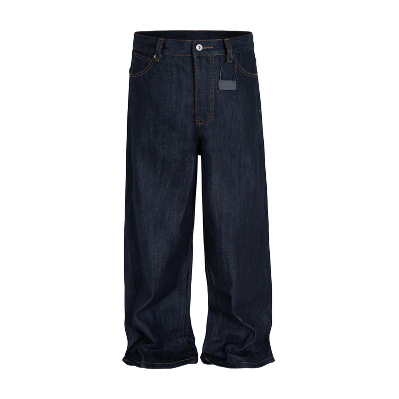 Front view of dark indigo straight-leg jeans with brown contrast stitching and tag on belt loop