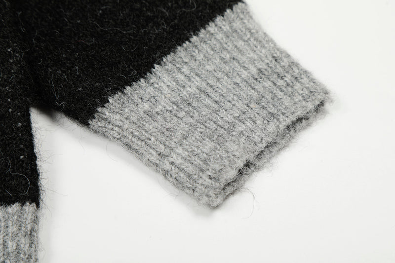 Close-up of gray ribbed knit cuff on a black and gray sweater
