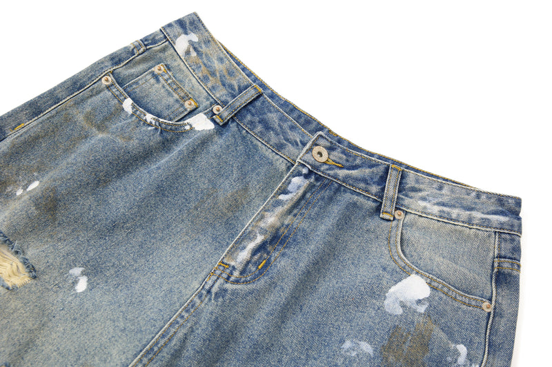 Close-up of front waistband and pockets on washed blue denim pants