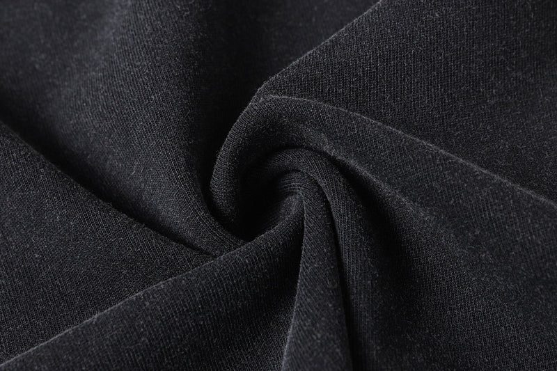 Close-up of black fabric texture gathered in soft folds