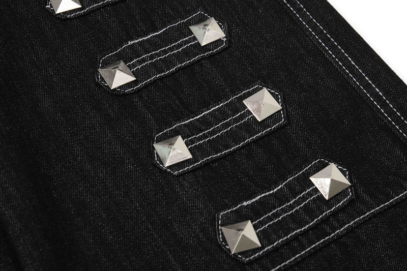 Close-up of black denim strap details with silver pyramid studs