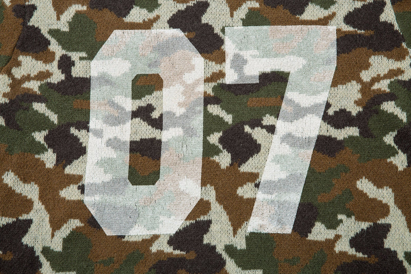 Close-up of the large 07 graphic on the back of a camouflage knit hoodie