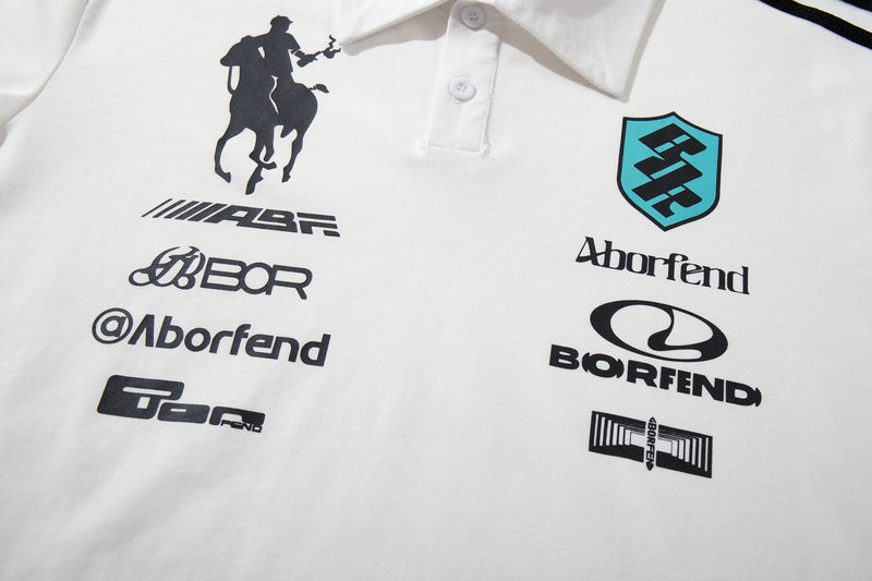 White polo shirt with racing crest logos, black sponsor graphics, and a turquoise Aborfend shield on the chest
