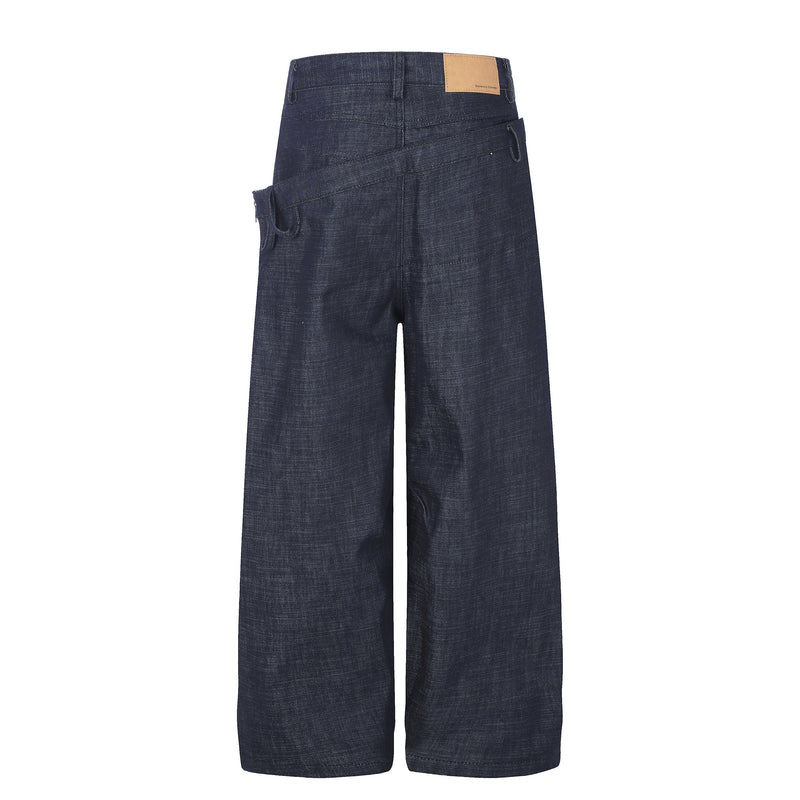 Back view of dark wide-leg jeans with layered waist and tan patch detail