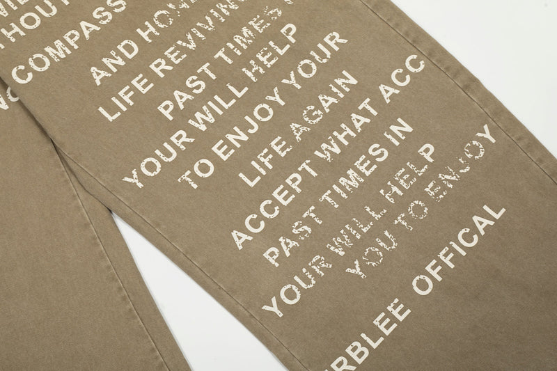 Close-up of text print on the leg of khaki wide-leg pants