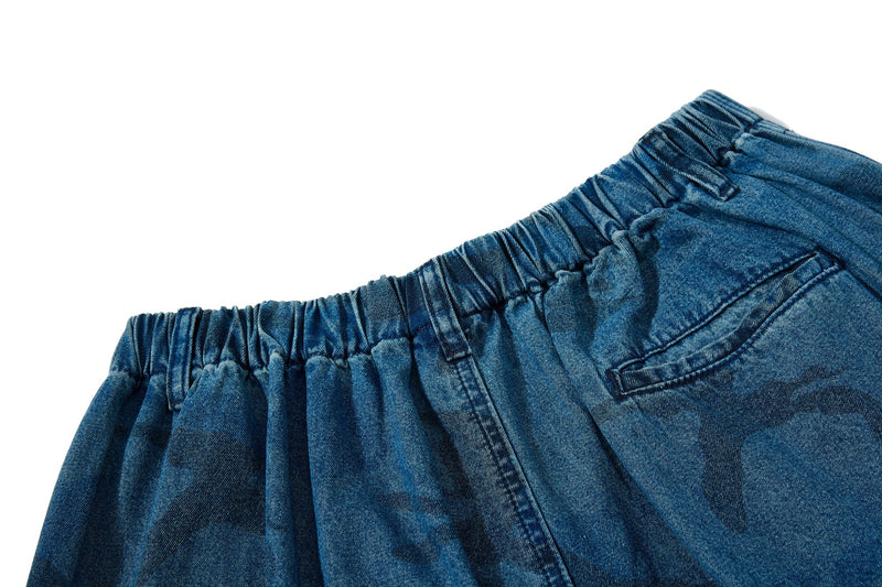 Close-up of back waistband and patch pocket on washed blue camo jeans