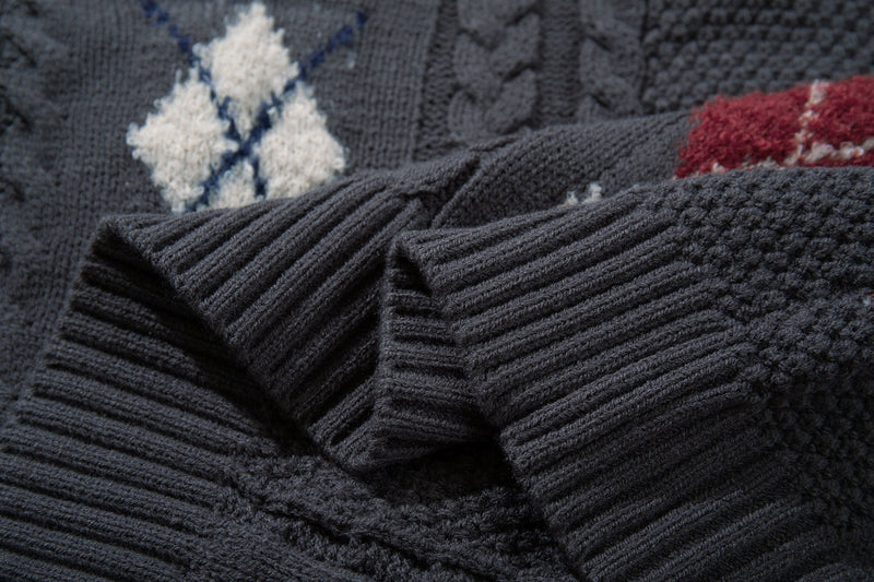 Close-up of dark cable knit cardigan with white argyle patch and ribbed cuff