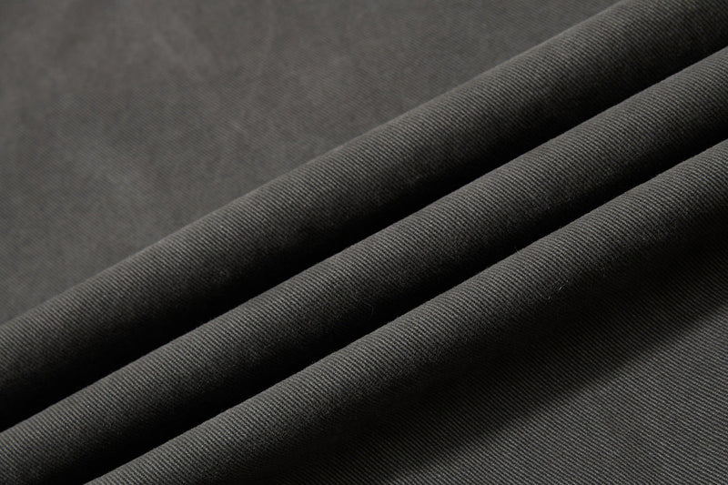 Close-up of black twill fabric texture with folded drape