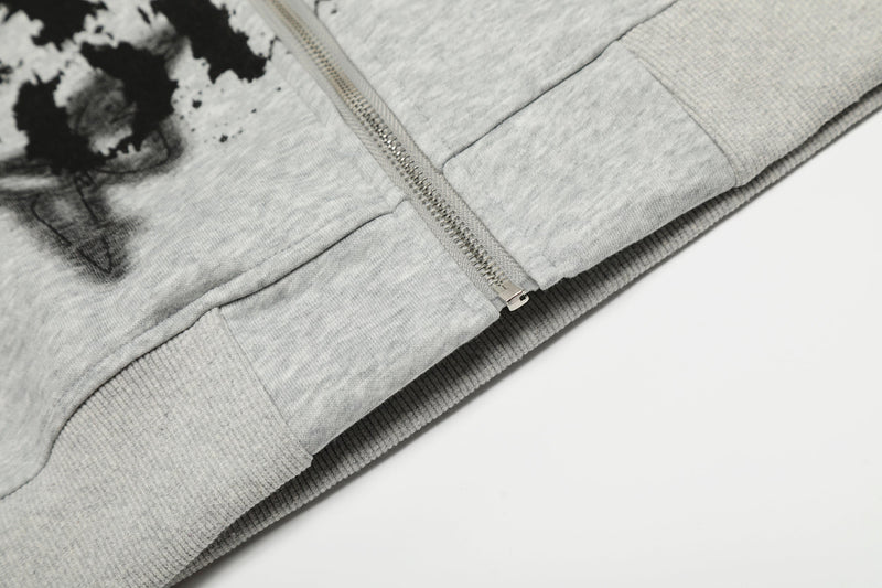 Close-up of light gray hoodie front hem with zipper and ribbed waistband