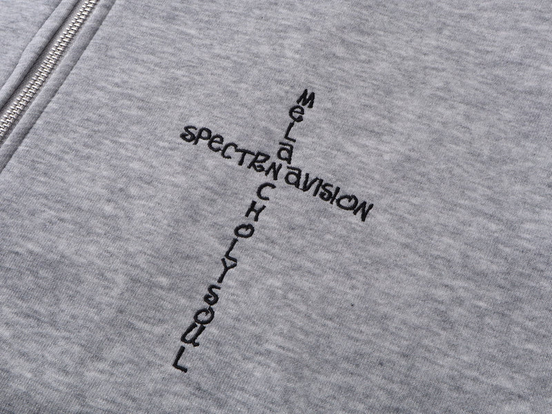 Close-up of gray hoodie chest print with vertical black Spectravision text