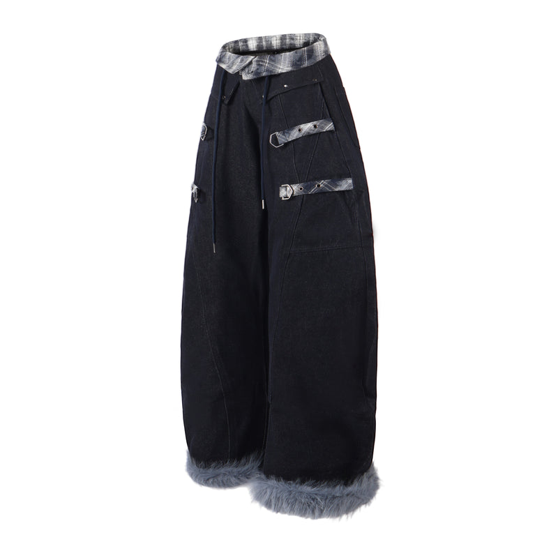 Side view of black barrel leg denim pants with gray plaid waistband and hanging drawstrings