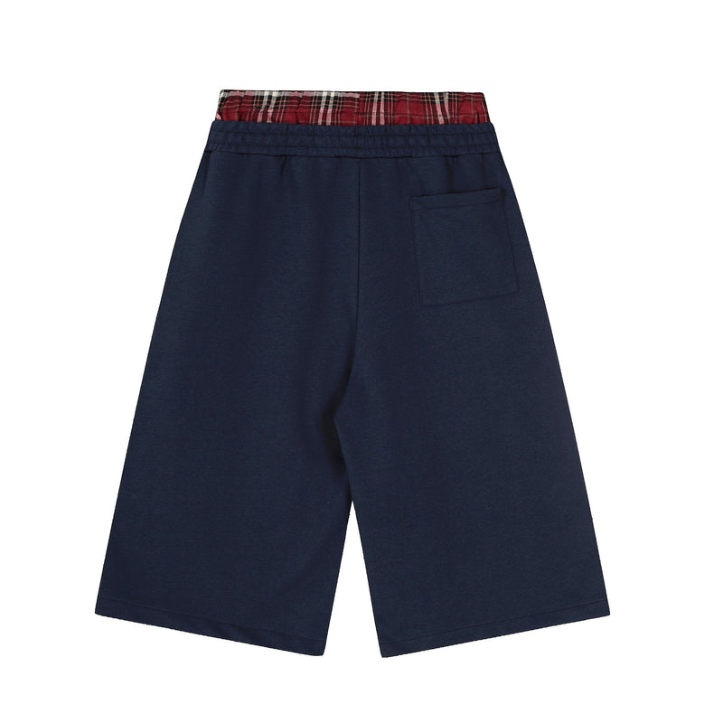 Back view of navy shorts with red plaid waistband and single back pocket