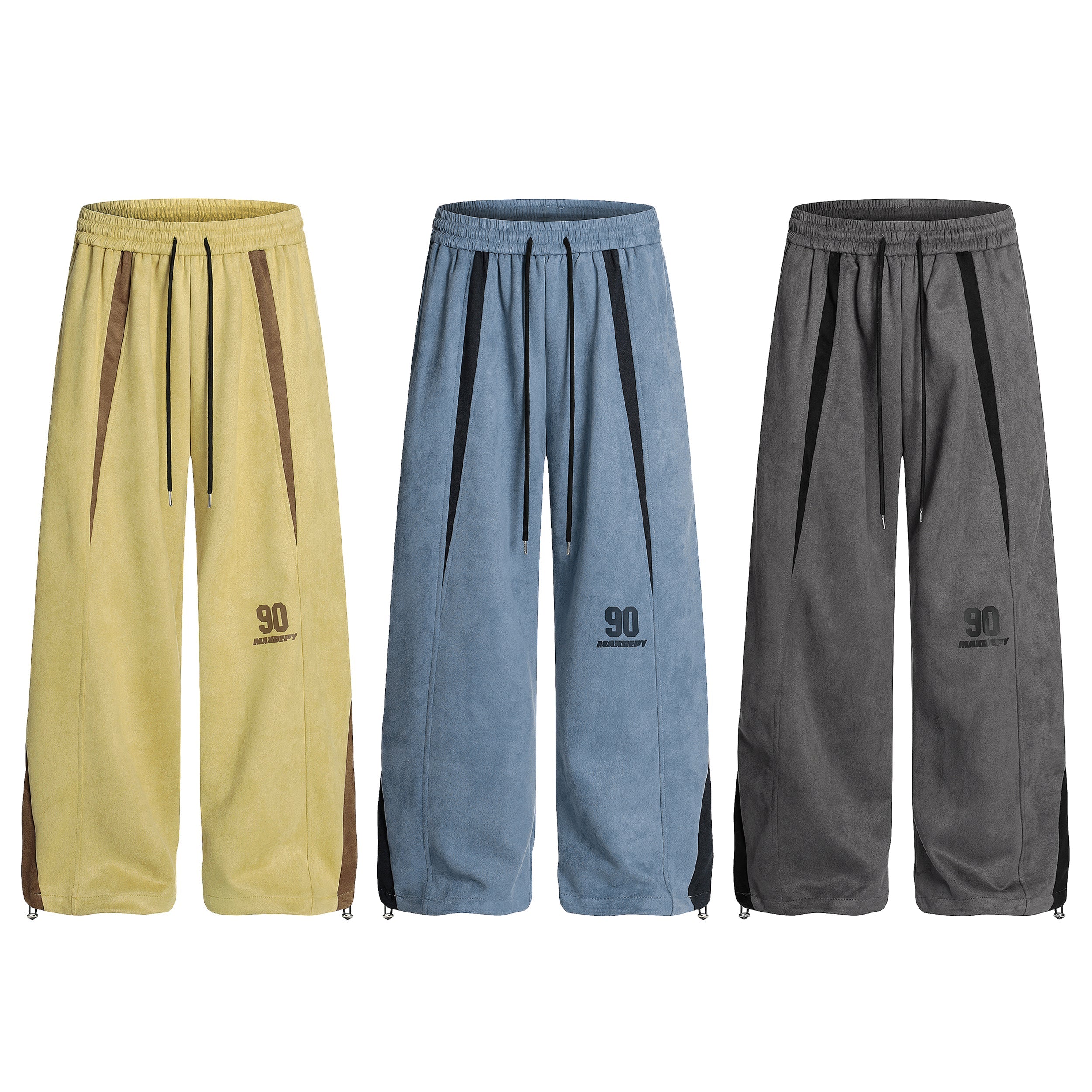 Three colorblock wide-leg track pants in yellow, blue, and grey with contrast side panels and drawstring waist