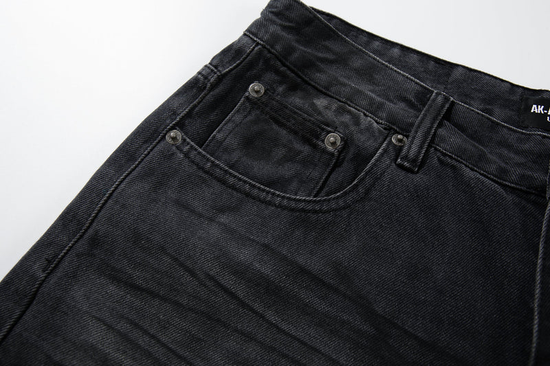 Close-up of front pocket and waistband on dark faded jeans with metal rivets
