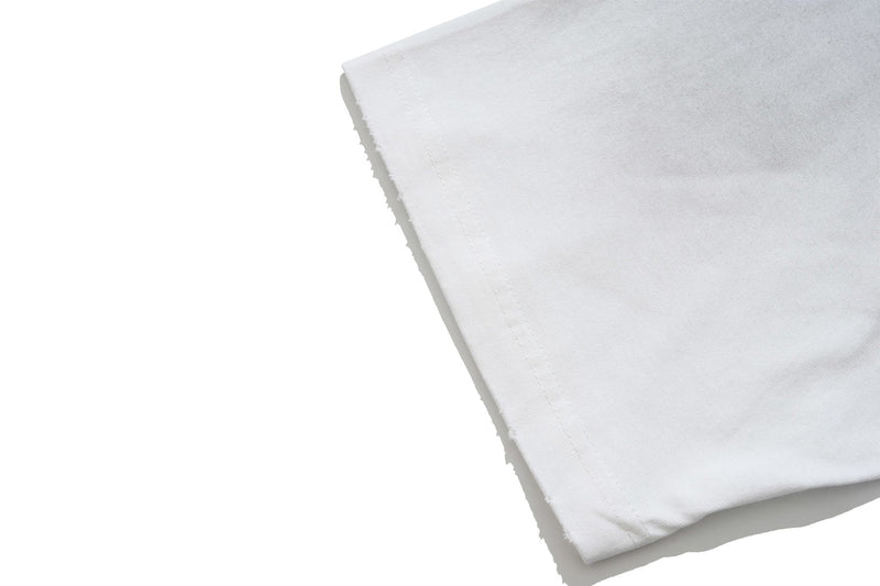 Close-up of folded white graphic T-shirt sleeve with stitched hem and soft cotton fabric texture