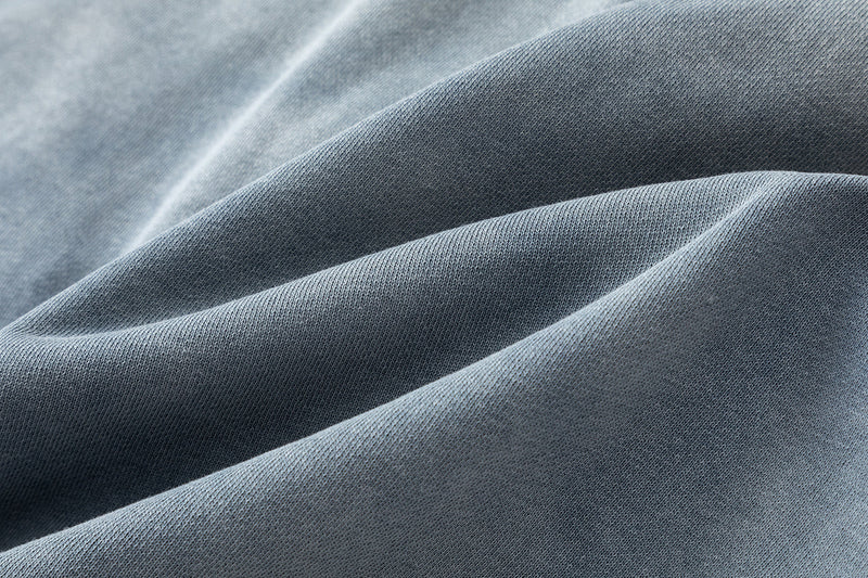 Close-up of washed blue cotton fabric with soft textured folds