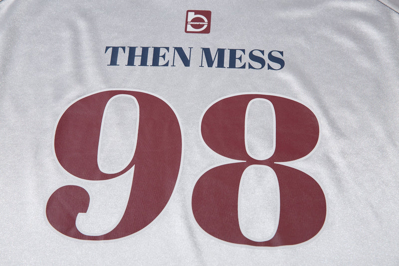 Close-up of white jersey tee front with THEN MESS and 98 graphic