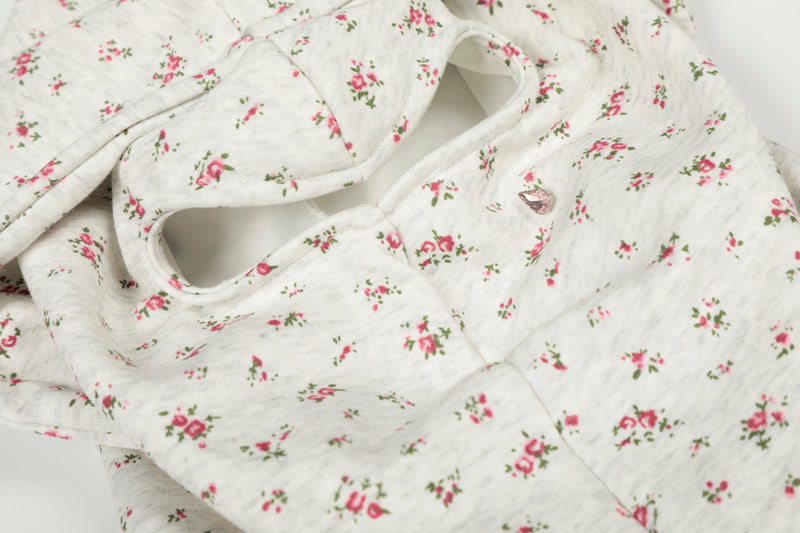 Close-up of floral hood face opening with pink teardrop zipper pull detail