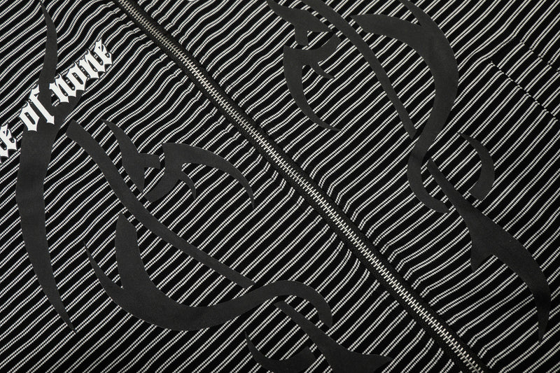 Close-up of front graphic print on black striped zip hoodie