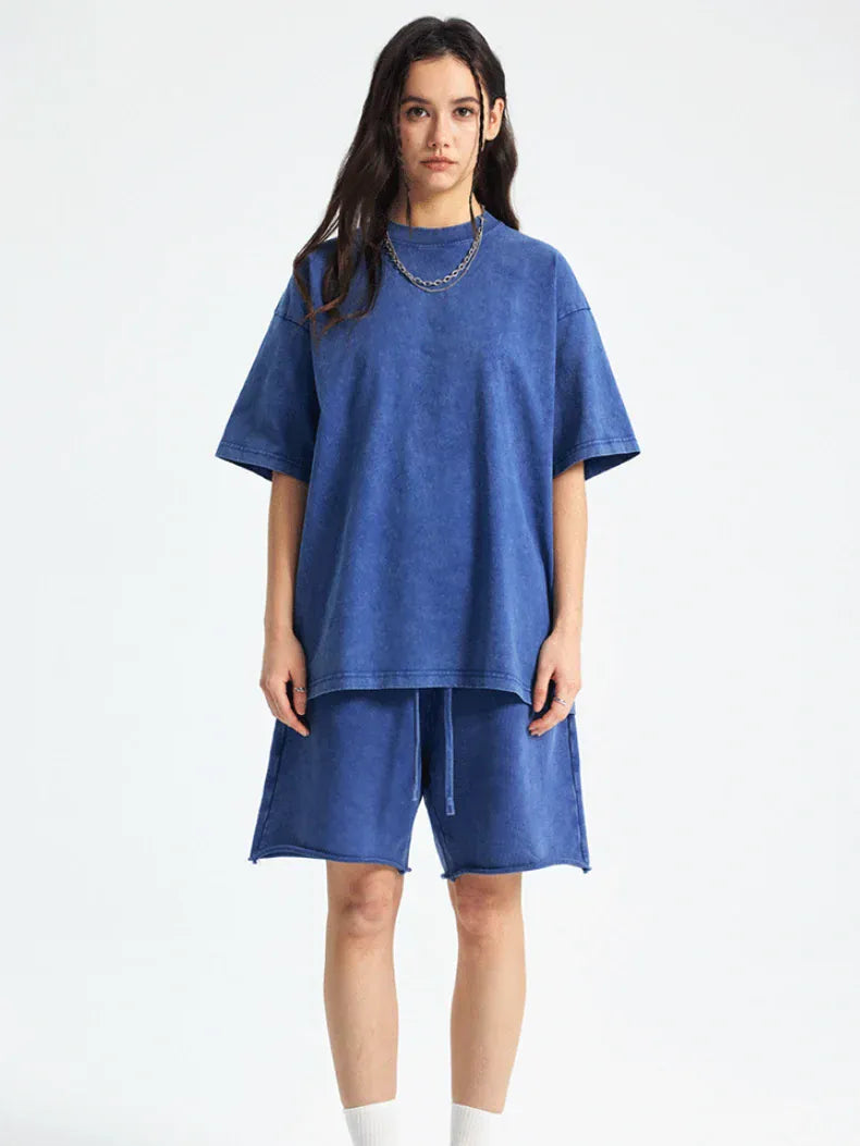 A person wears the Custom Anime Character Periwinkle Blue Washed T-Shirt - Personalized Anime Style Tee with matching blue shorts, standing facing forward against a plain white background.
