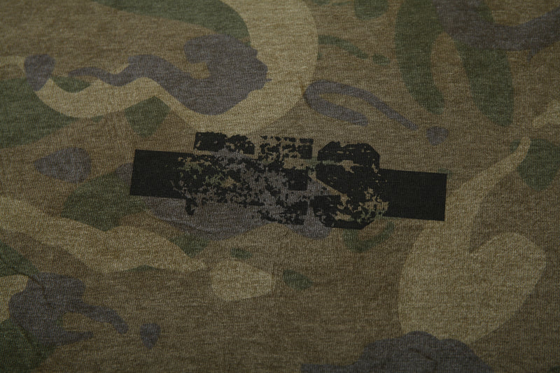 Close-up of distressed chest graphic on camo long sleeve tee with printed black bar detail