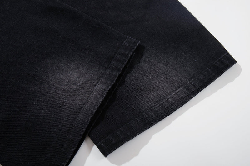 Close-up of the lower leg hem on dark wide-leg jeans