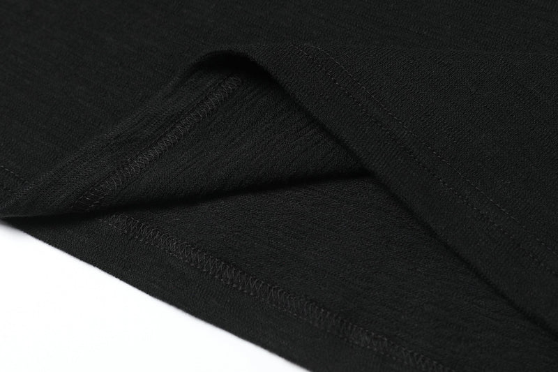 Close-up of black knit fabric with visible seams and texture