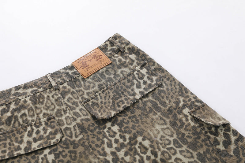 Back pocket detail on leopard print cargo shorts with leather logo patch at the waistband