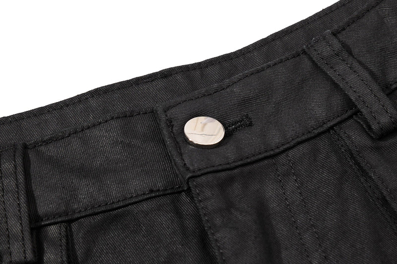 Close-up of black waistband snap button and top stitching on cargo shorts