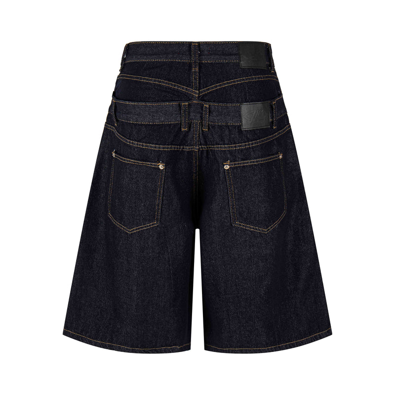 Back view of dark wash wide fit denim shorts with stacked waistband and pockets