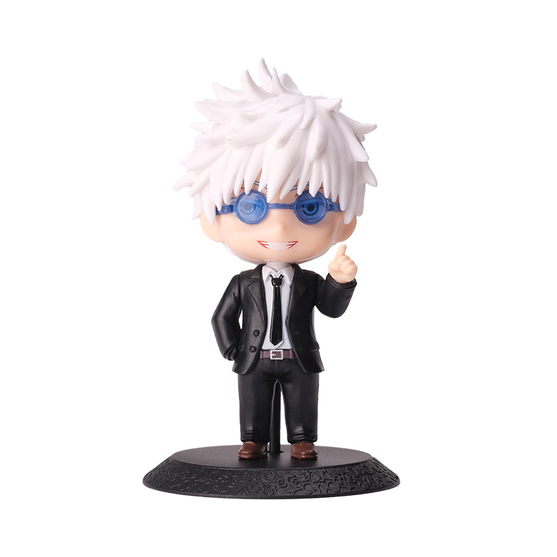 A 10cm chibi-style Gojo Satoru figure, from the Jujutsu Kaisen action figure set, features spiky white hair, blue glasses, and a sleek black suit with a tie. Standing on a textured black base, this collectible displays a smiling expression and playful hand gesture.