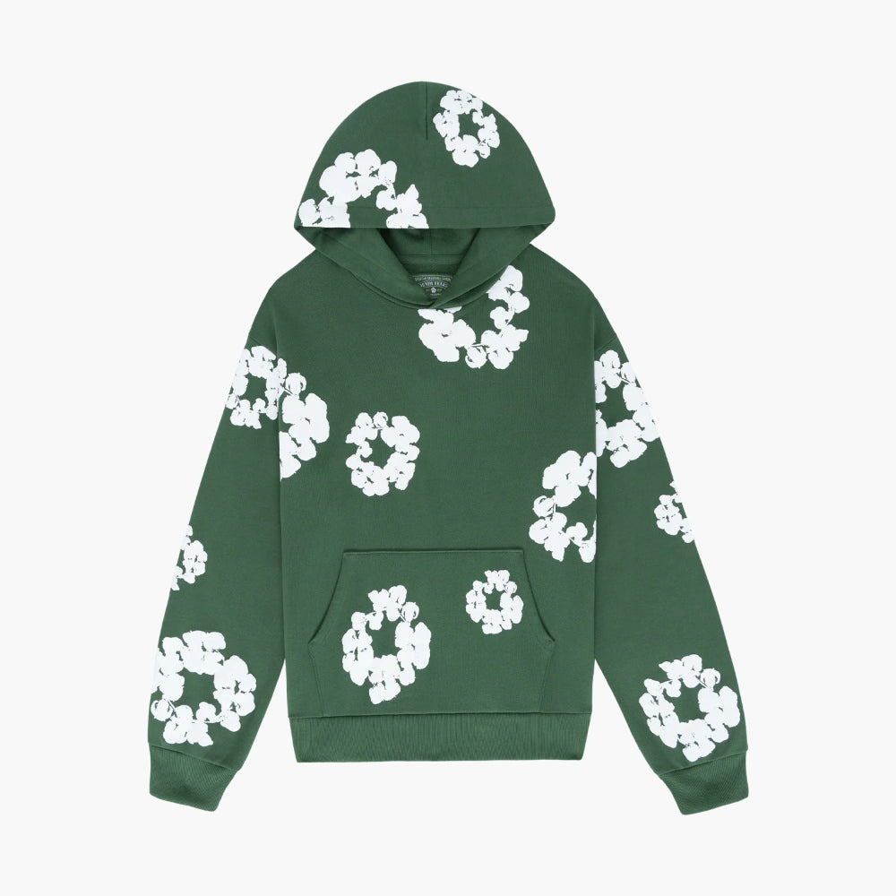 The Forest Green “Cotton Wreath” Denim Tears Hoodie is a streetwear pullover made from soft cotton fleece with a front pocket and bold white floral prints, inspired by the iconic Denim Tears style.