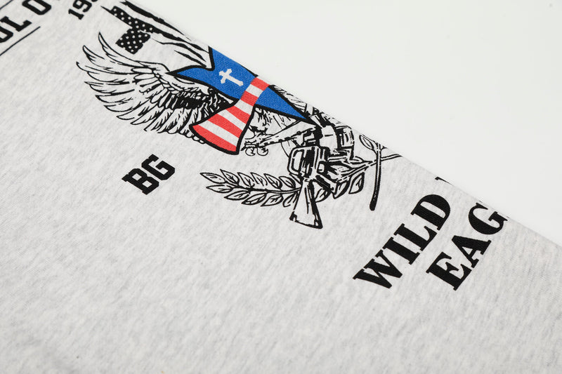 Close-up of white sleeve with eagle graphic, blue and red accents, and black text