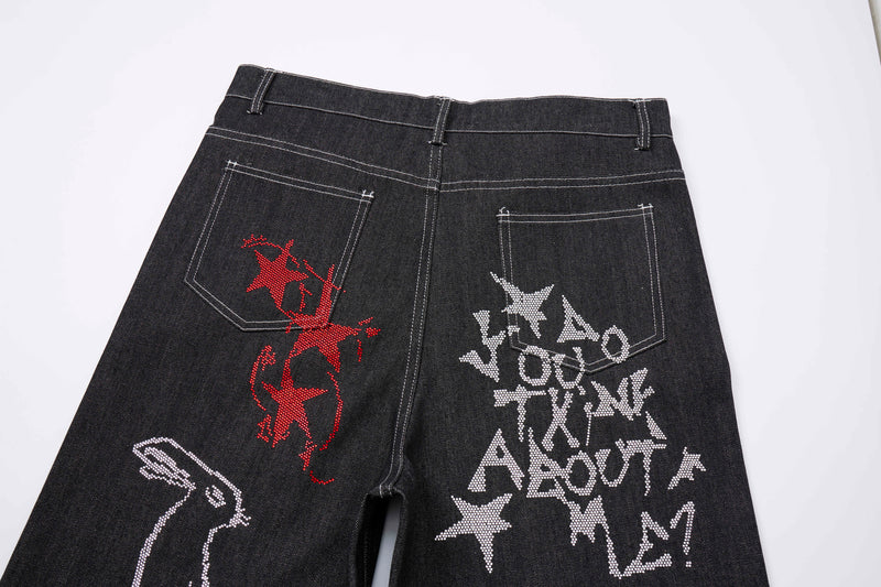 Back waist view of black streetwear jeans with back pockets and rhinestone graffiti graphics