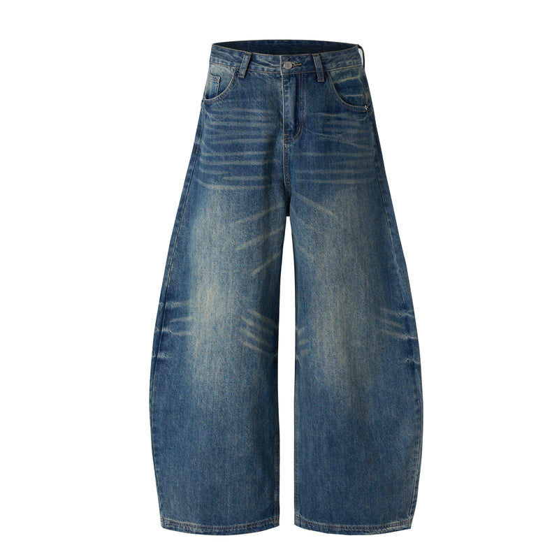 Front view of vintage washed blue wide-leg jeans with high waist and faded whiskering