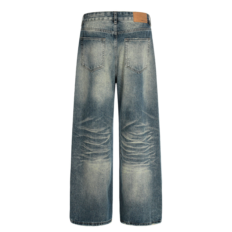 Back view of vintage washed wide-leg jeans with faded denim and patch back pockets