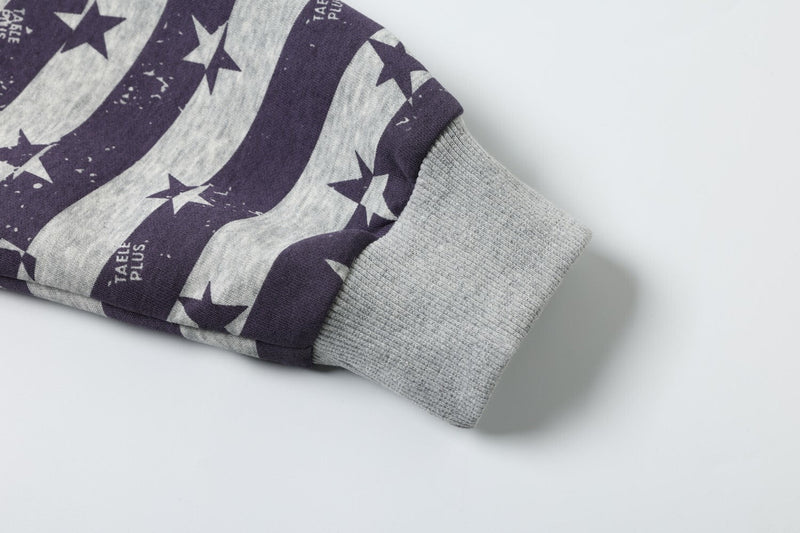 Close-up of a gray ribbed sleeve cuff on a purple and gray star print hoodie