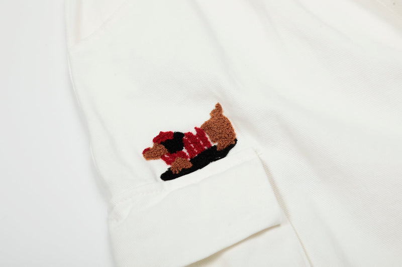 Close-up of white cargo shorts dog embroidery on cargo pocket